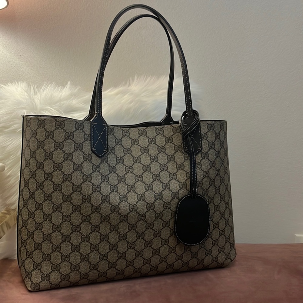 Gucci reversible tote in monogram tan and black.